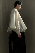 Side view of Bernadette cream organza silk blouse with flowing silhouette