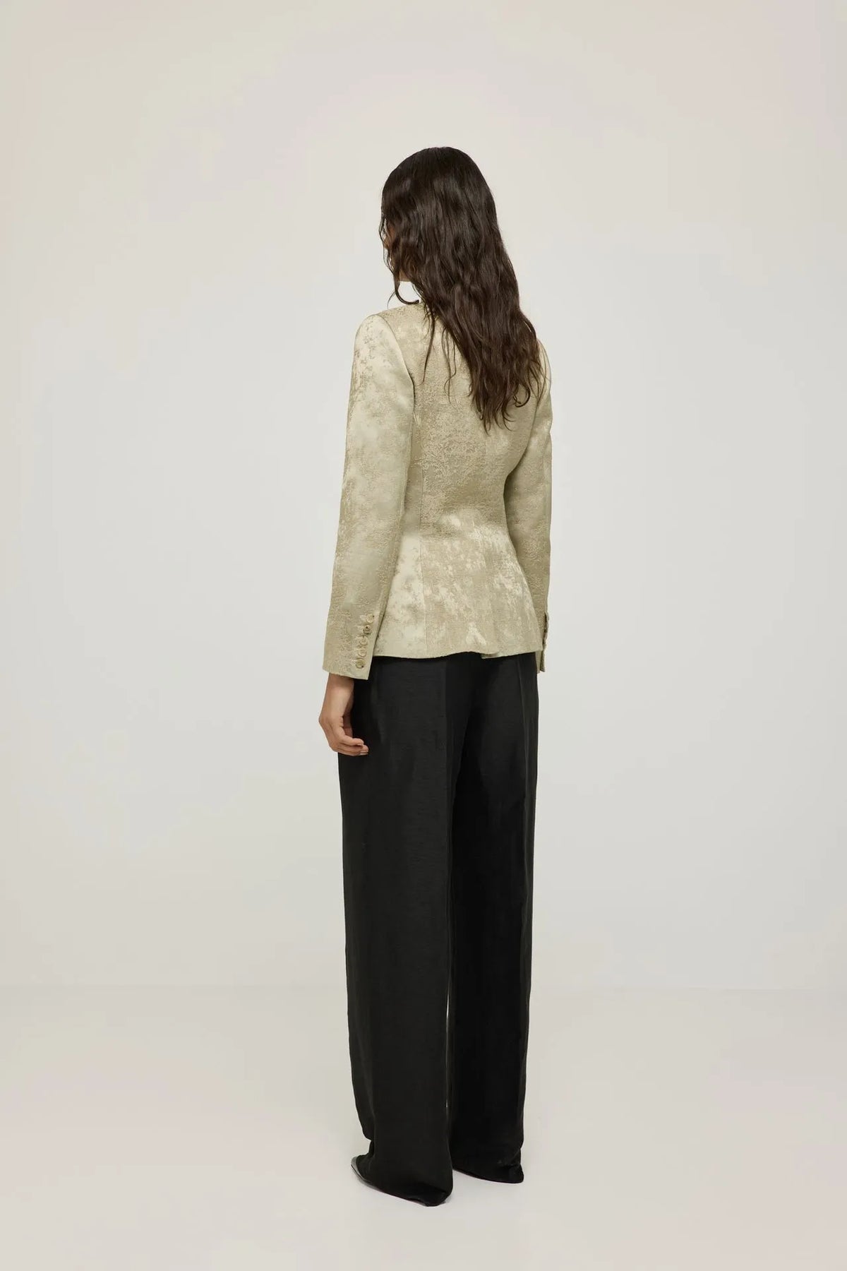 Left side view of the Margaret gold blazer, showing its tailored fit.