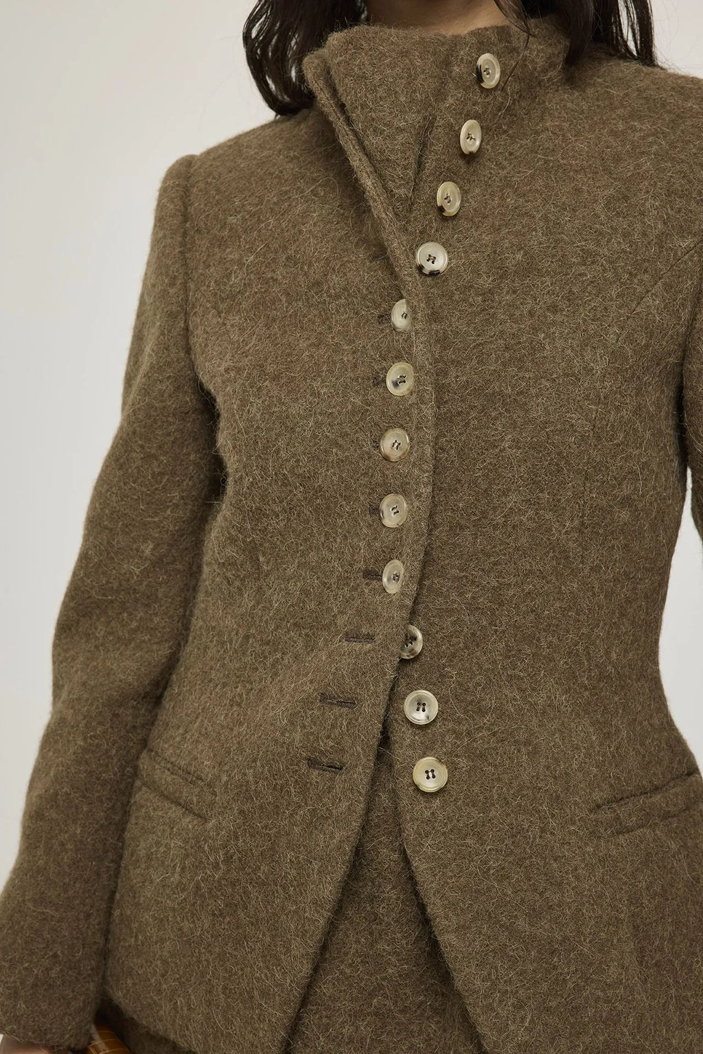 Close-up of the high collar and brown alpaca wool fabric on the Margaret blazer.