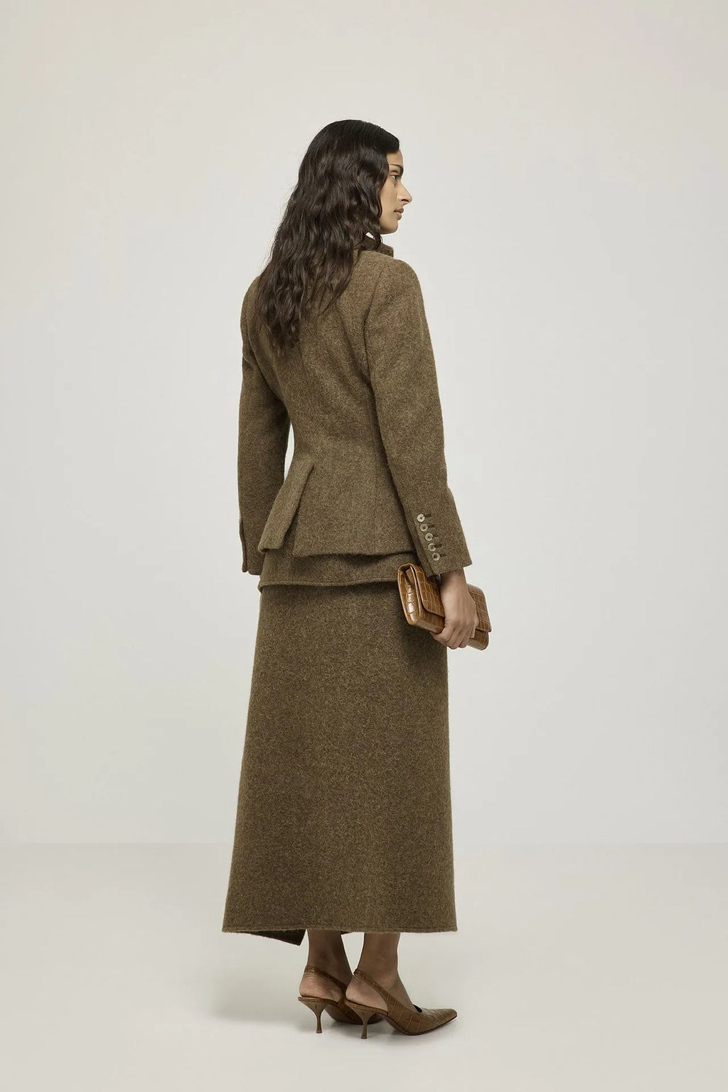 Back view of the Margaret brown blazer, showing its shaping through the waist.