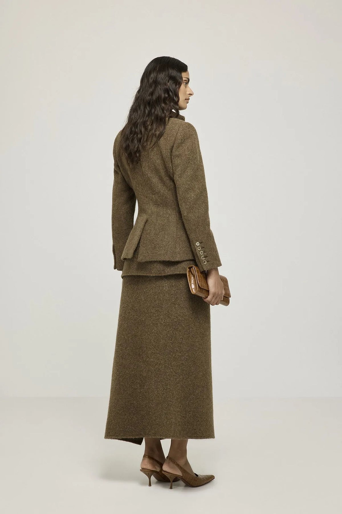 Back view of the Margaret brown blazer, showing its shaping through the waist.