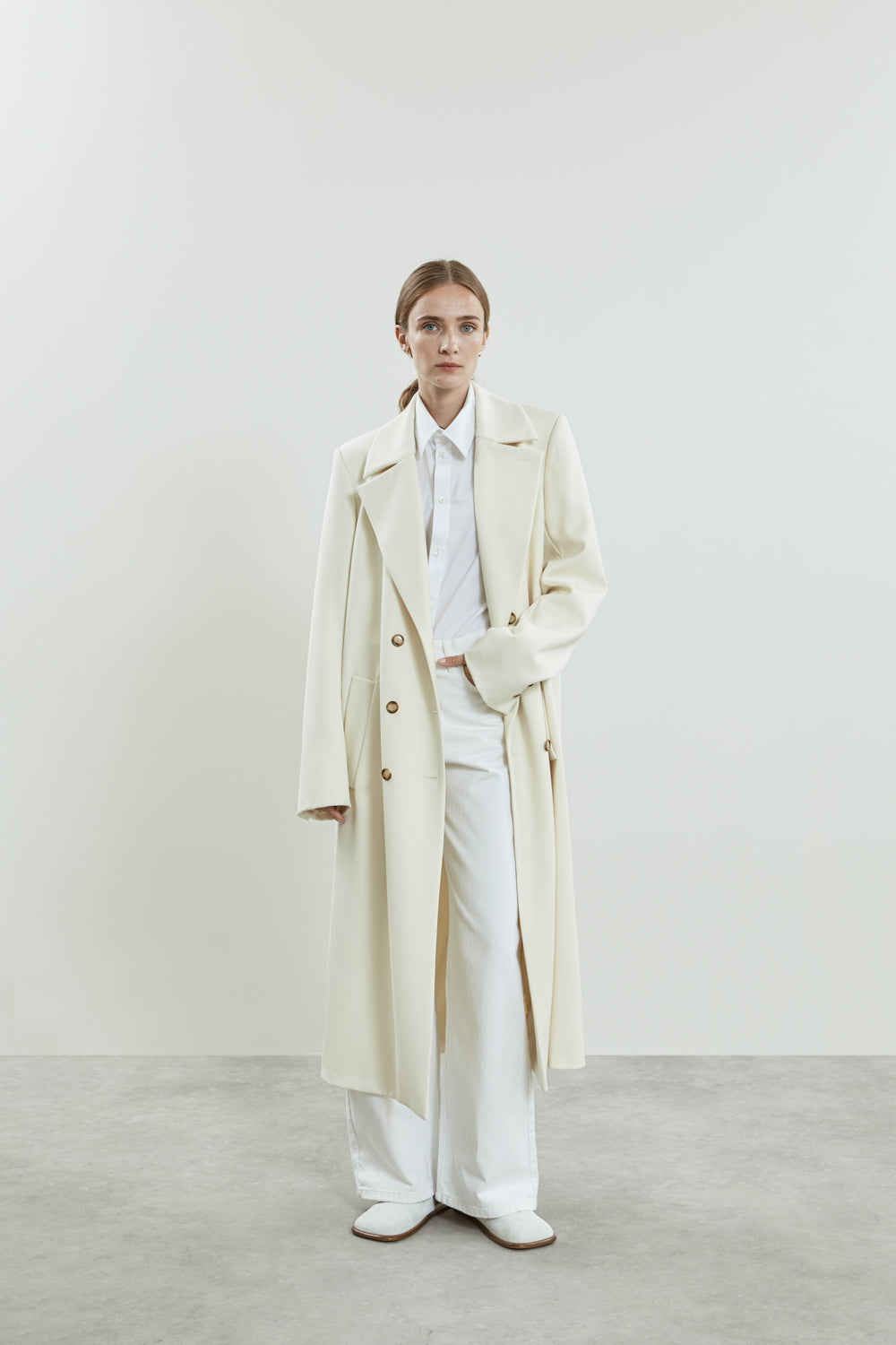 Front view off-white Achilles coat made from soft virgin wool.