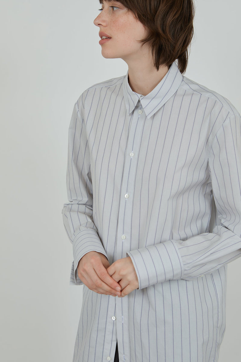 Woman wearing a classic striped men's shirt. 