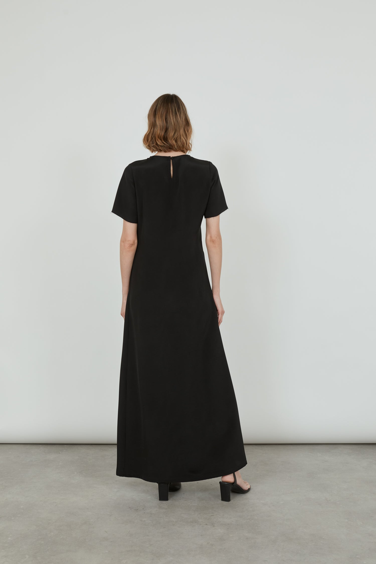 Back view of the black Celine dress in crepe silk.