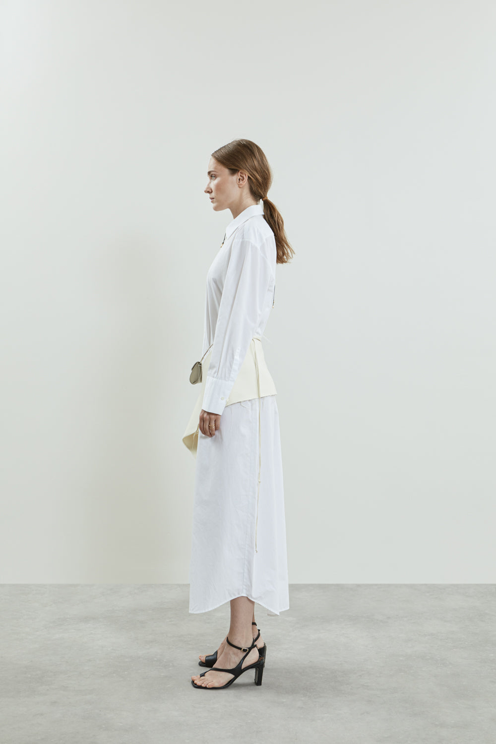 Side view of the off-white Ellis scarf, showcasing the elegant envelope-style pockets with tonal buttons.