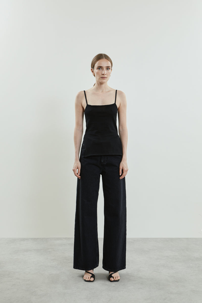 Front view of the black Harlow knitted top in cotton knit, featuring a square neckline, delicate straps, and side slits.