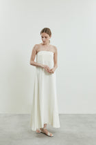 Front view of the of white Joan dress in crepe silk, featuring open shoulders and a sleek silhouette.