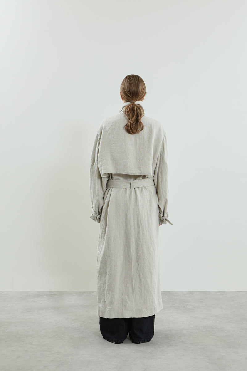 Back view of the beige Jocasta coat, highlighting its longline design and adjustable belt.