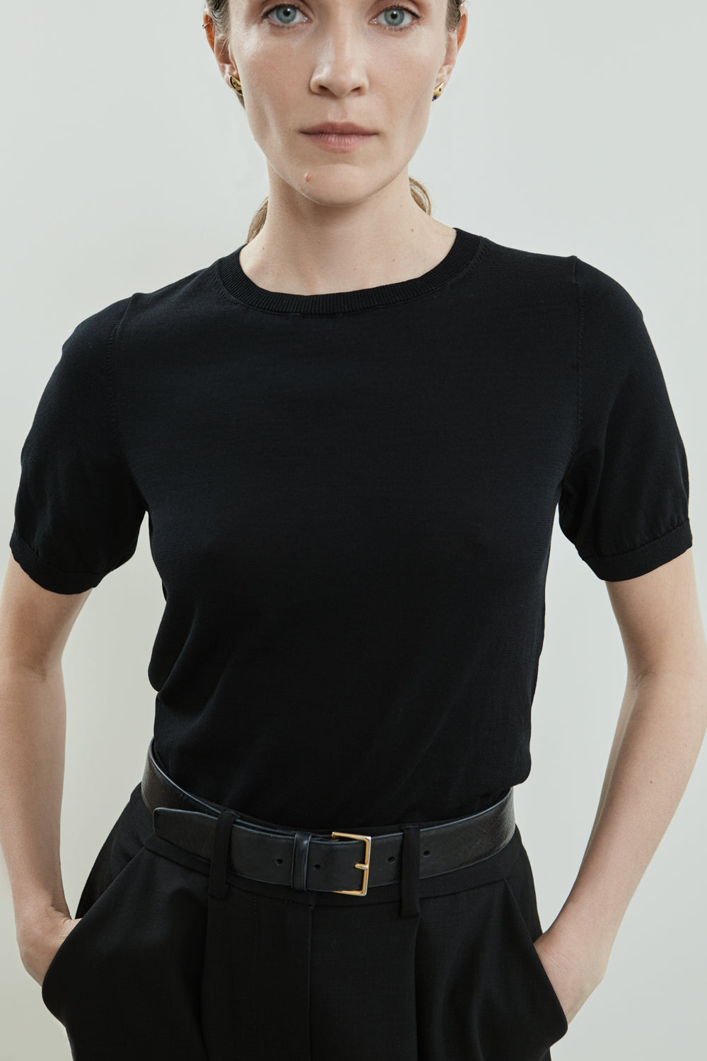 Close-up of the black cotton knit fabric and crew neckline of the Josepha T-shirt.