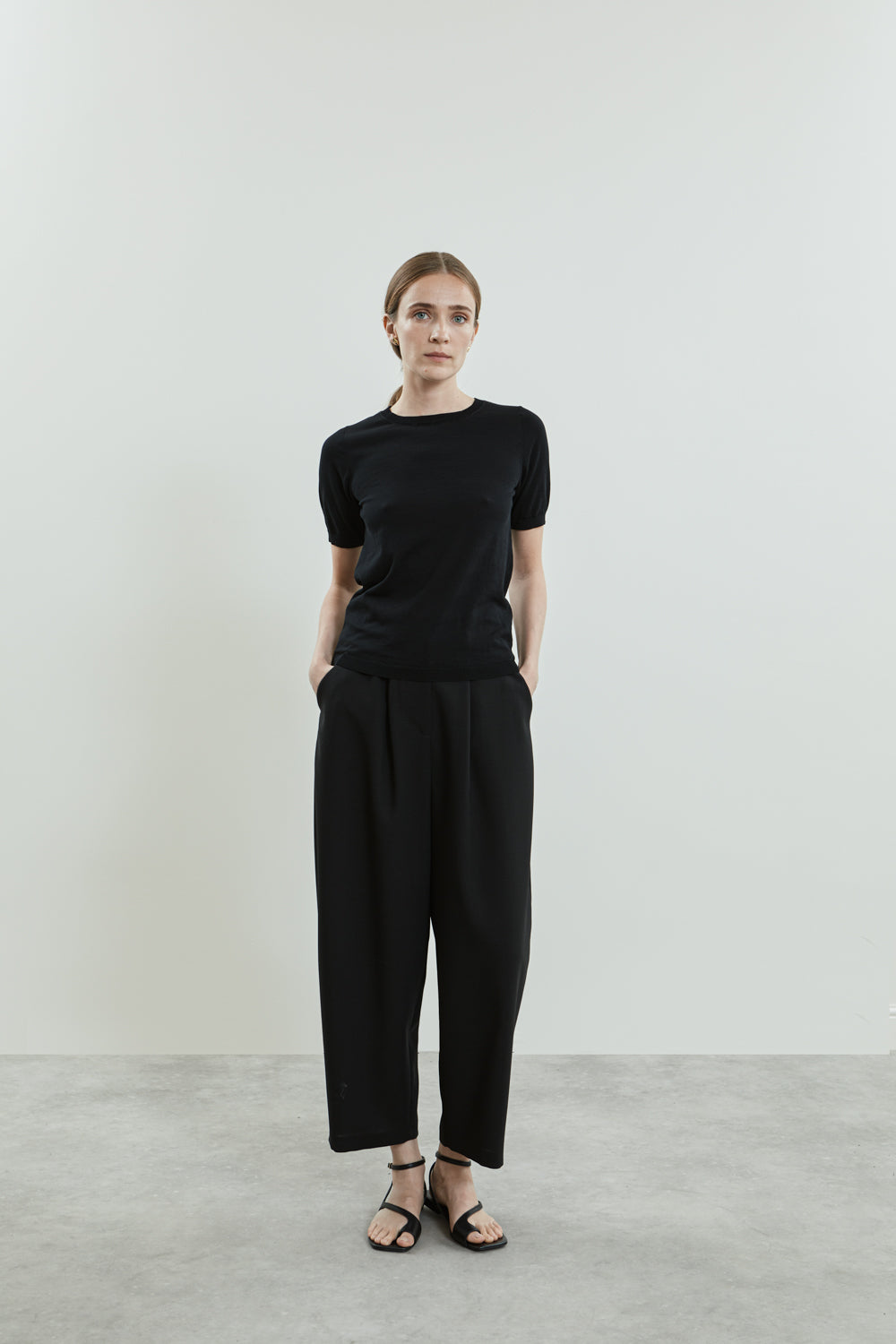 Full-length view of the black Josepha knitted T-shirt in cotton knit, designed with short sleeves, a crew neckline, and ribbed trims.