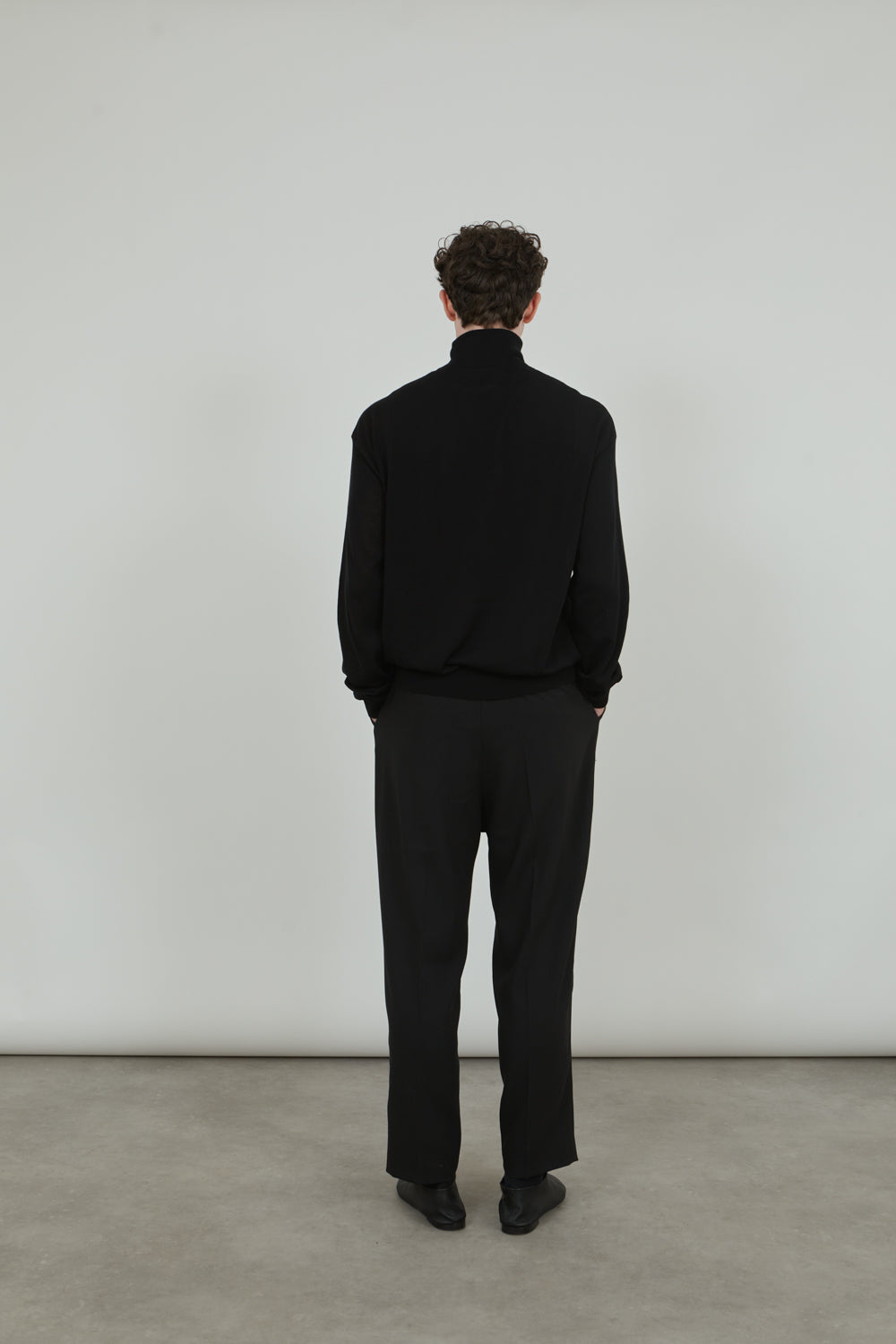 Back view of the black Julien knitted turtleneck.