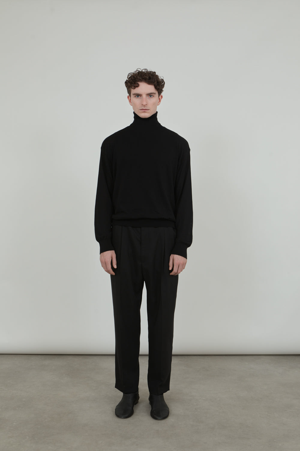 Front view of the black Julien knitted turtleneck in soft cotton knit.