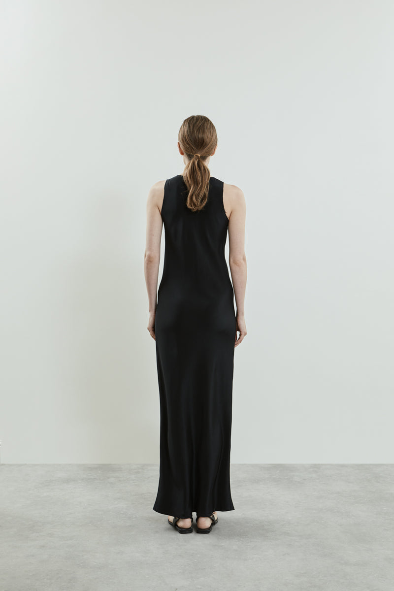 Back view of the black Kate dress, highlighting the sleeveless design and the smooth crepe silk fabric.