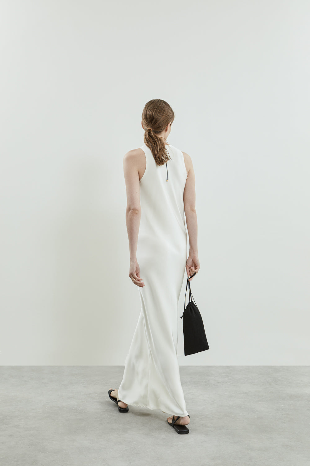 Back view of the off-white Kate dress, highlighting the sleeveless design.