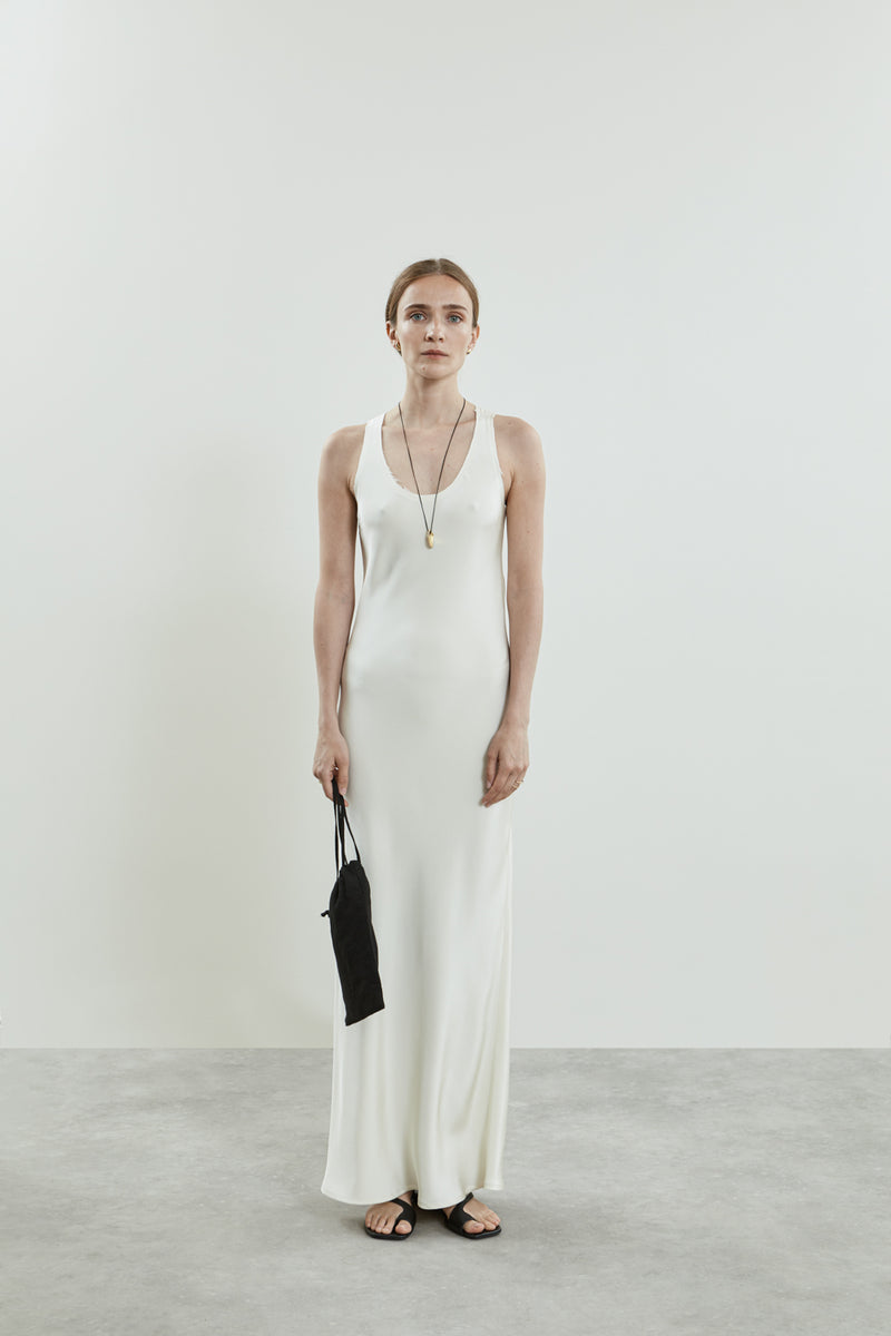 Front view of the off-white Kate dress in crepe silk, featuring a sleeveless design, smooth fabric and scooped neckline.