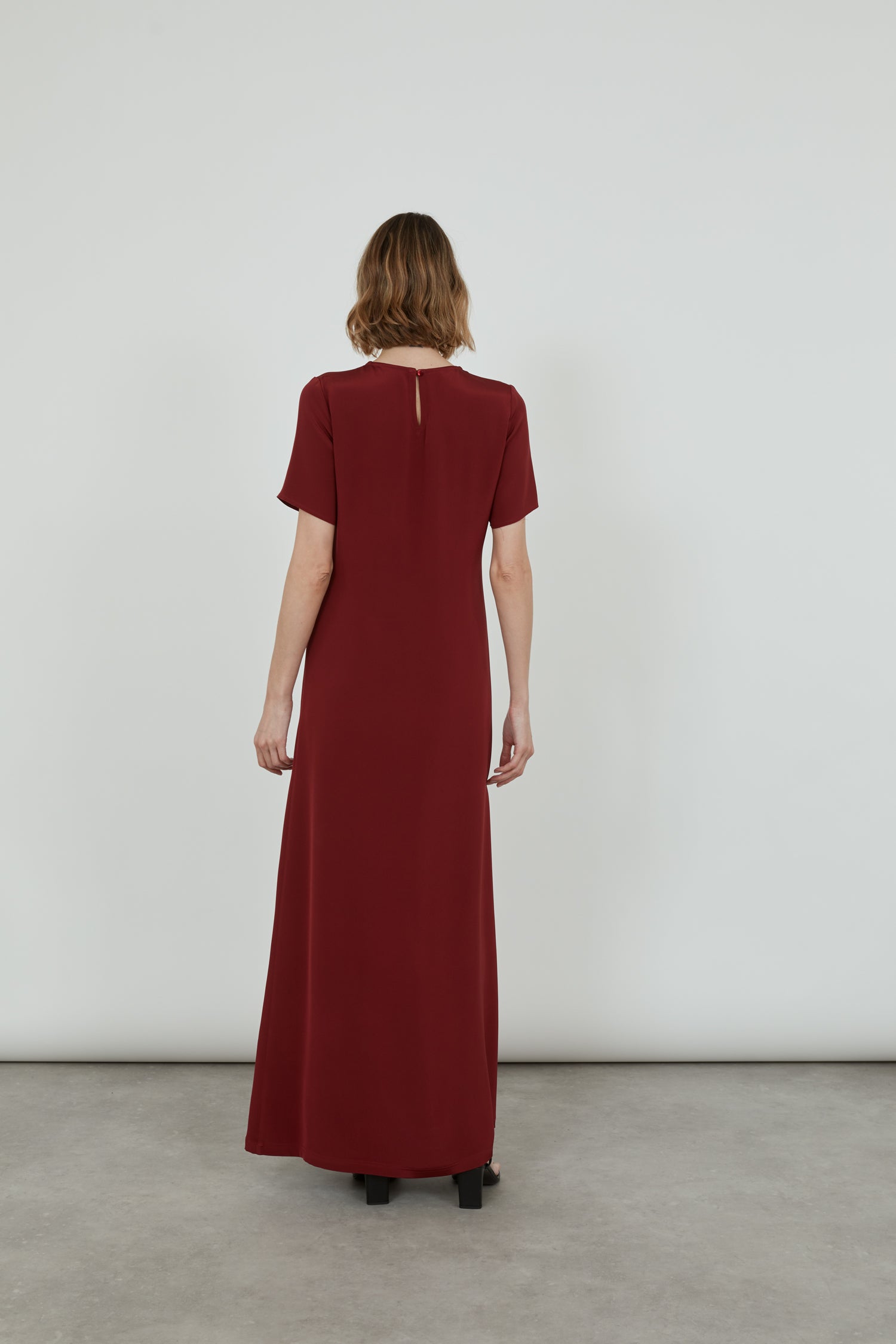Back view of the red Celine ankle-length dress in crepe silk.