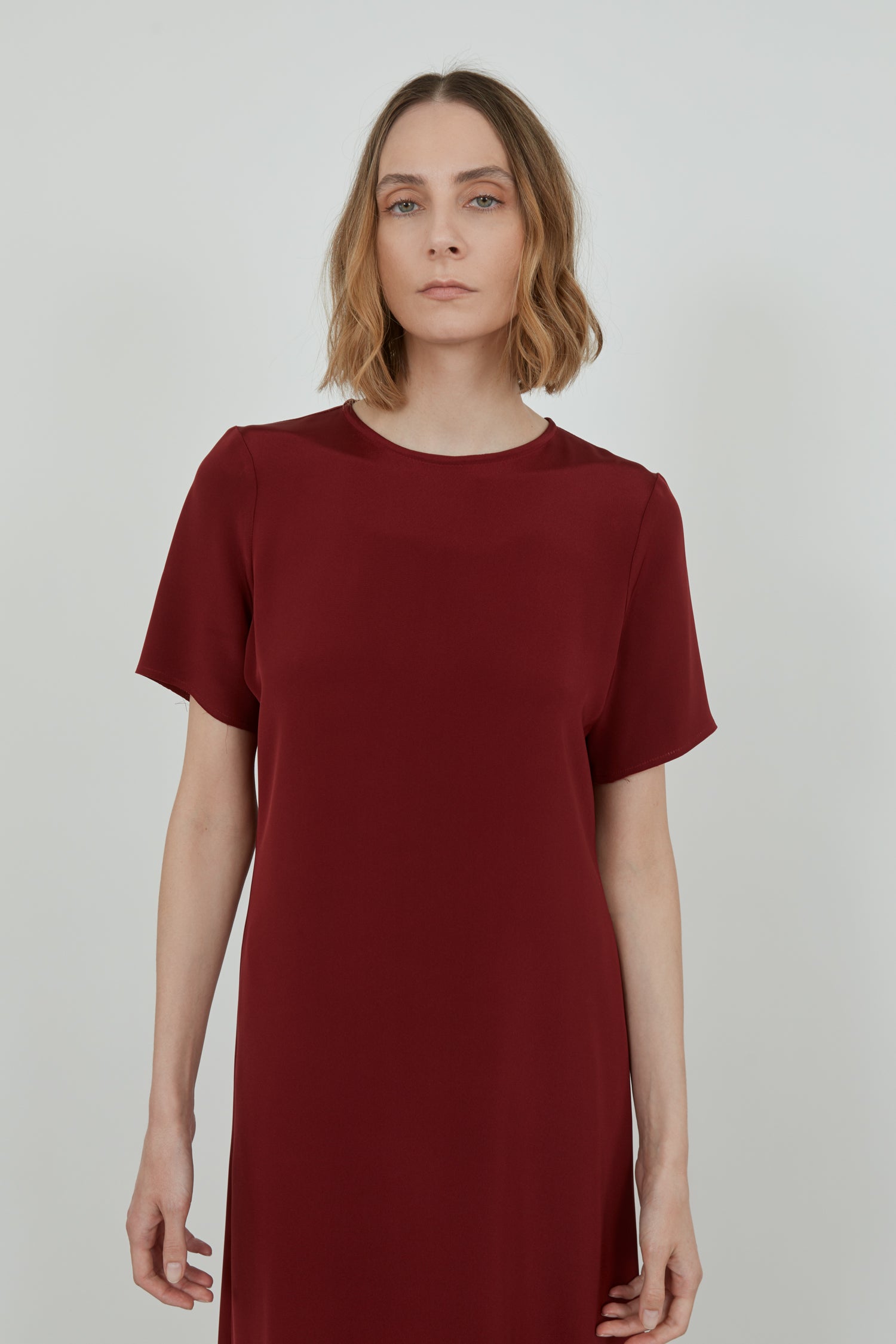 Close-up of the red crepe silk fabric of the Celine dress.