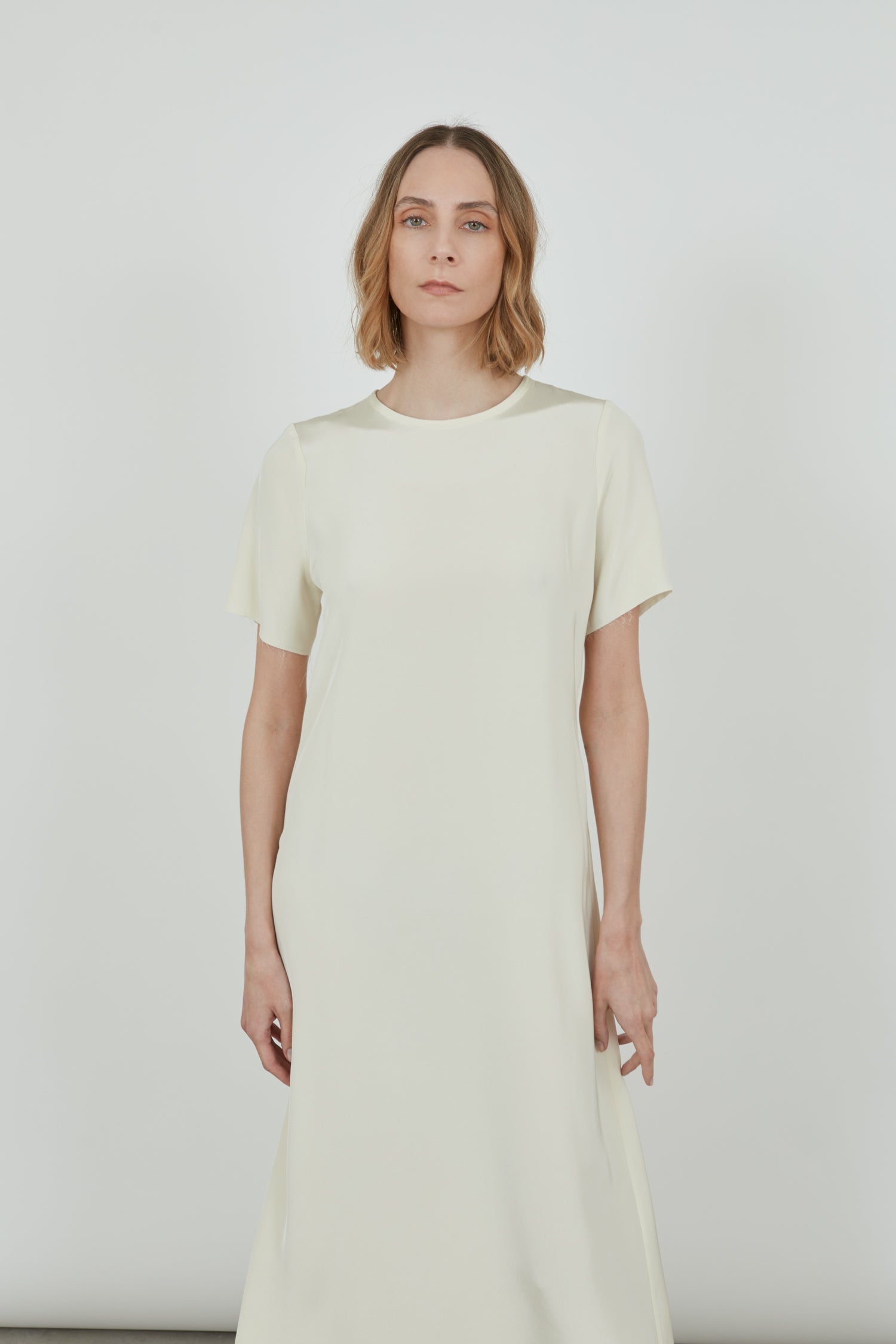 Close-up of the off-white crepe silk fabric of the Celine dress.