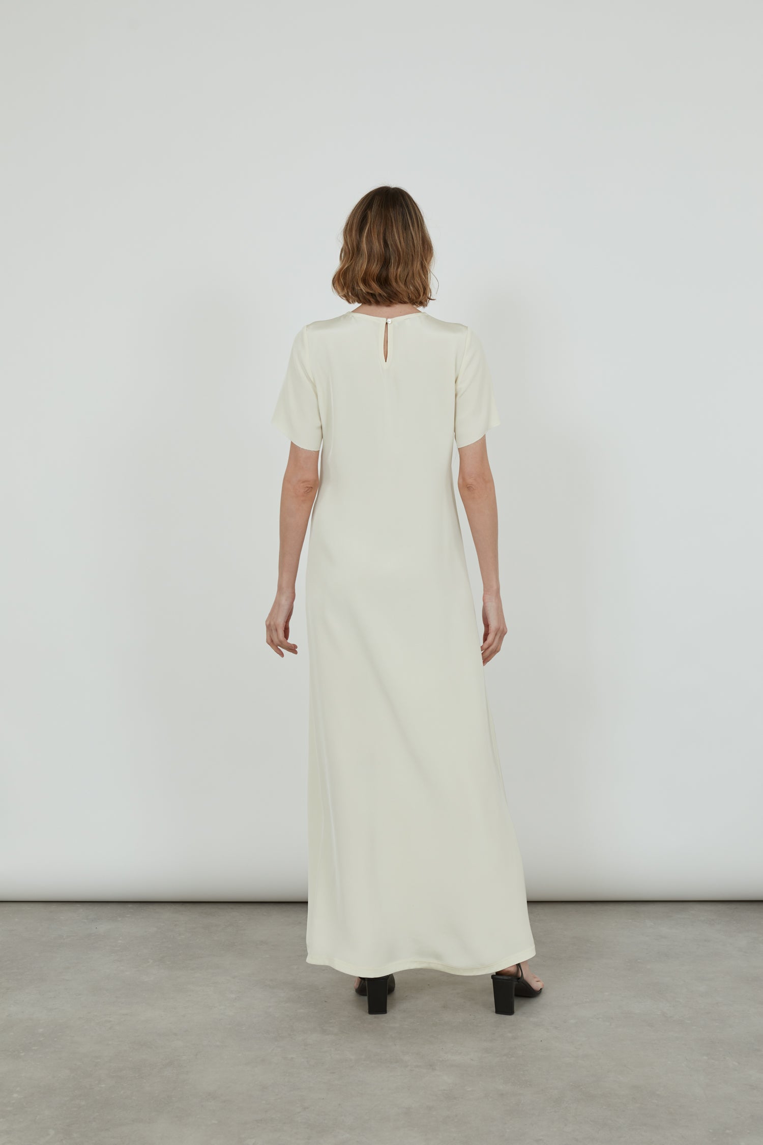 Back view of the off-white Celine ankle-length dress in crepe silk.