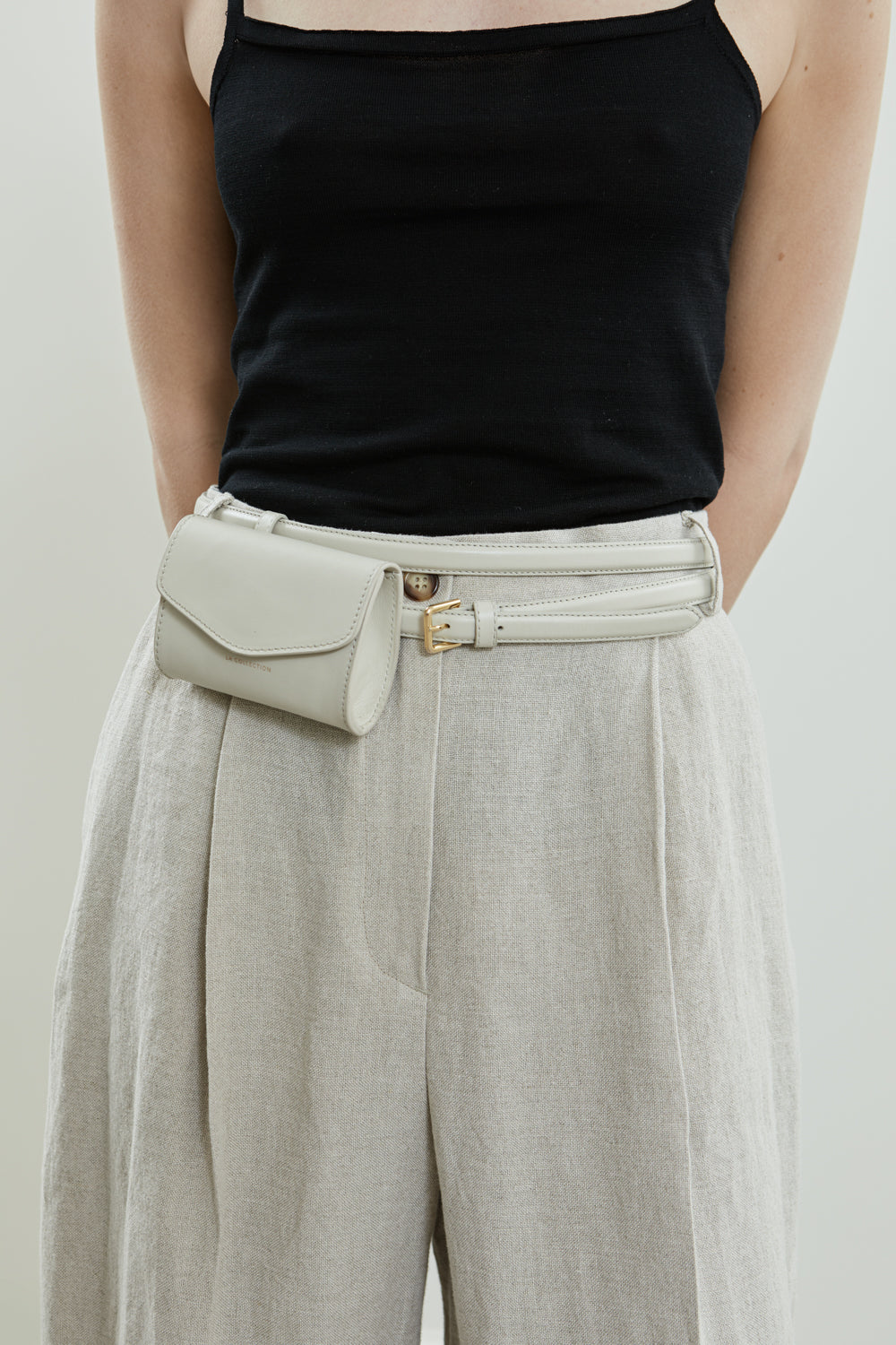 Close-up of the cream leather Colombina double belt and luca wallet bag.