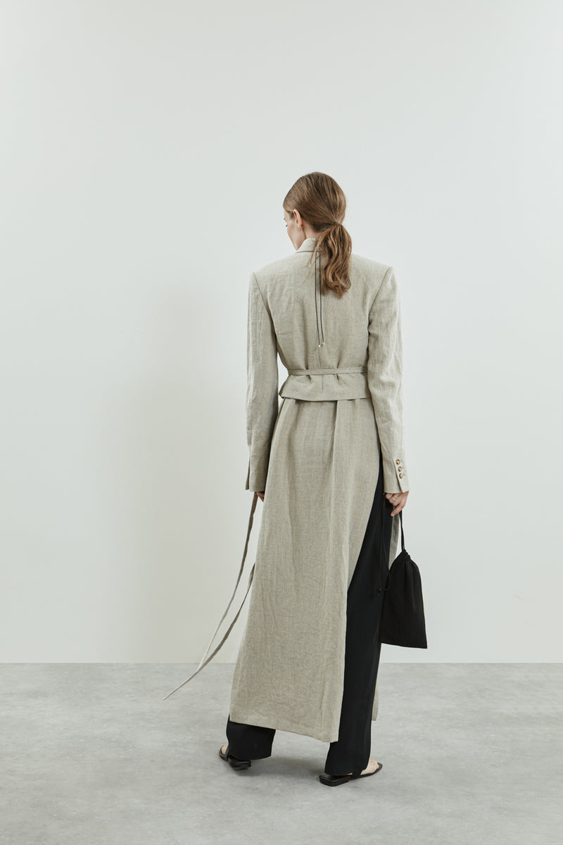 Back view of the Lynn blazer in beige linen, highlighting its clean silhouette.