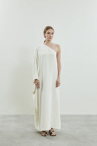 Front view of the Maui dress in off-white crepe silk, featuring a one-shoulder design.