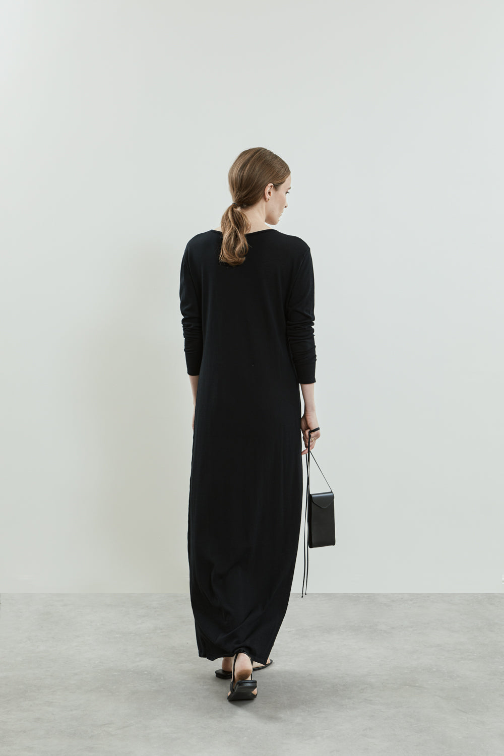 Back view of the Olive knitted dress in black cotton knit.