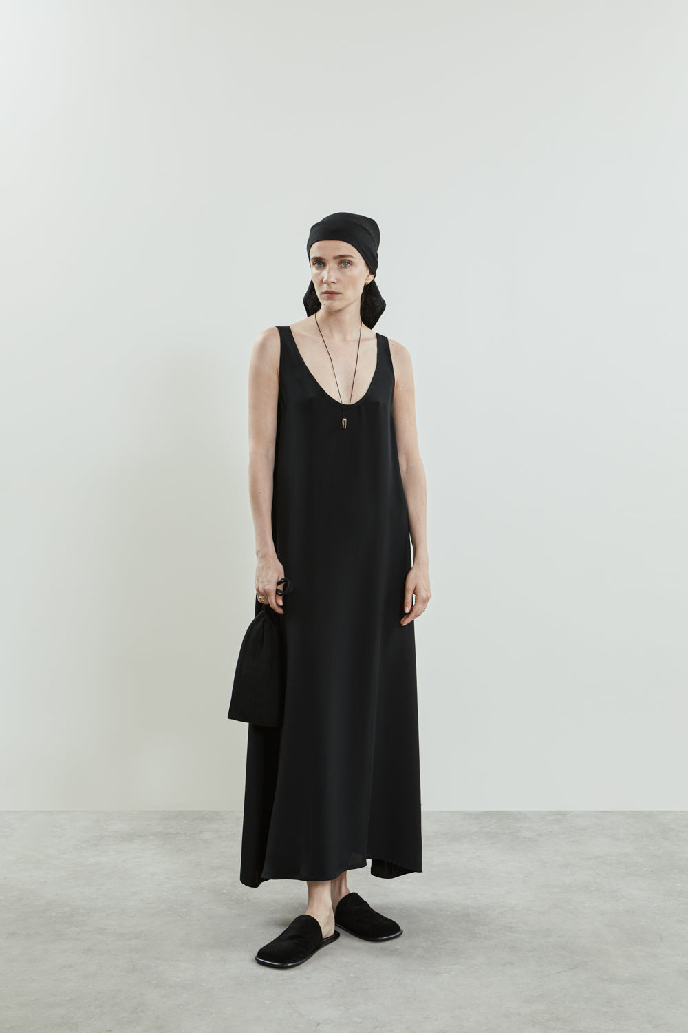 Front view of the Quinn dress in black crepe silk, featuring a graceful A-line silhouette and a floor-length design.