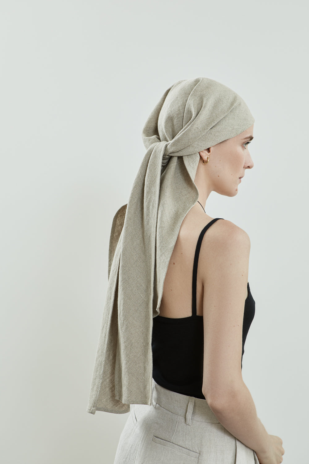 Close-up of the Roshan headscarf in beige Japanese linen.