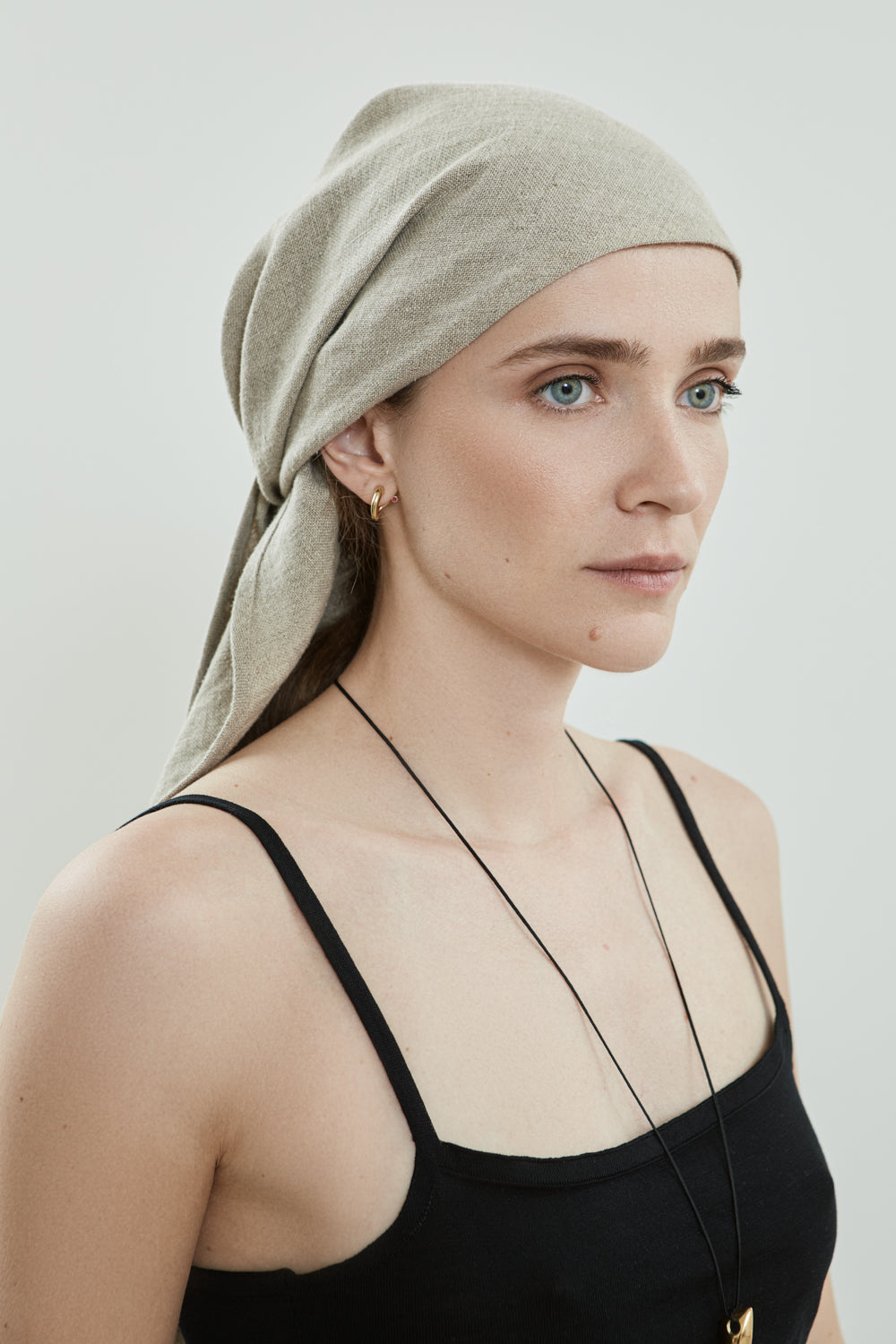 Flat view of the Roshan headscarf in beige Japanese linen.