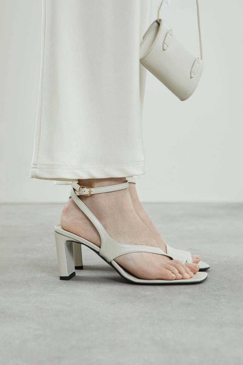 Full view of the Rosie sandals in cream leather.