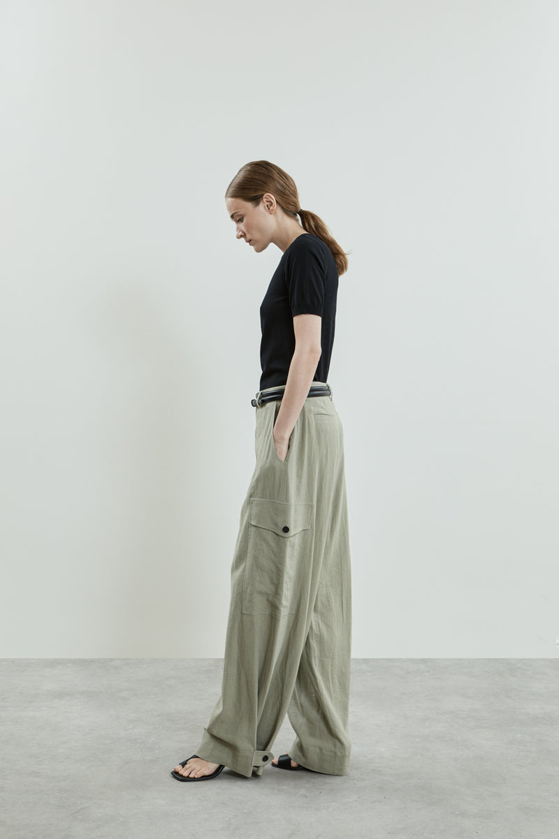 Side view of the Stein trousers in sage linen, featuring a high waist.