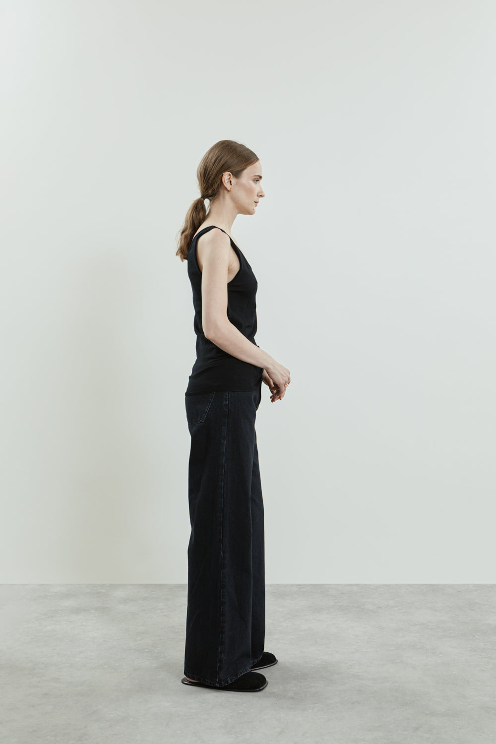 Side view of the Suzy knitted top in black cotton knit.