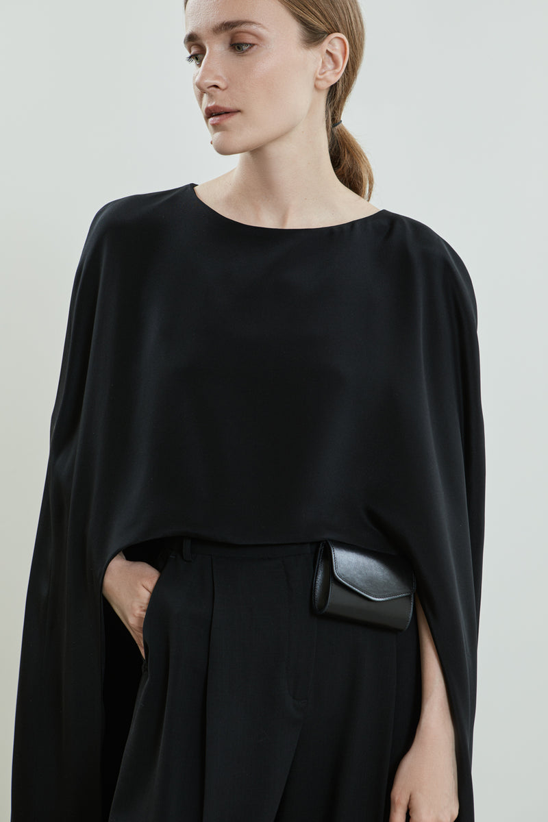 Front view of the Ursula cape in black crepe silk.