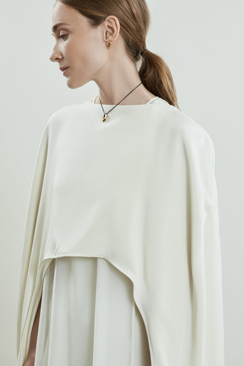 Close-up of the Ursula cape in off white crepe silk.