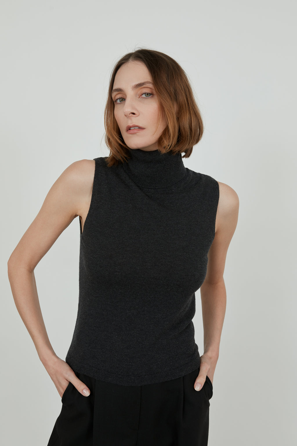 Deborah sleeveless turtleneck in the softest merino, cashmere and silk blend with black tailored trousers.