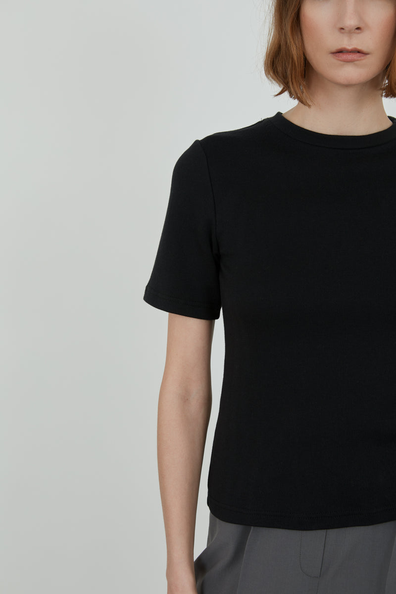 Detailed view of a black organic cotton T-shirt.